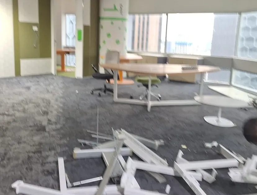 Dismantled workstations and debris on an office floor mid-reinstatement